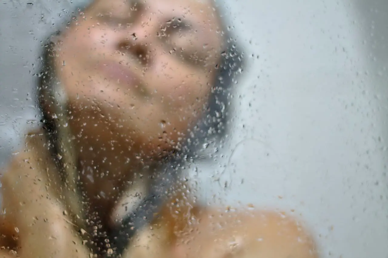 woman having a shower using the best tankless water heater